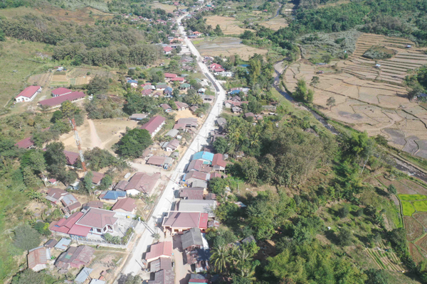 AN AERIAL VIEW OF A CONCRETE ROAD IN BAN NAM MO ANOUVONG DISTRICT, XAISOMBOUN PROVINCE